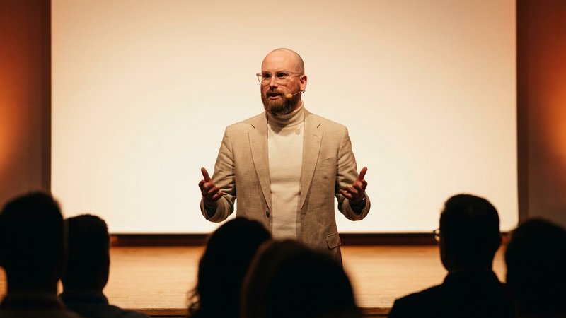 James Miller speaking on a conference stage